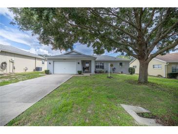 Single-story home with attached garage and mature landscaping at 9698 Sw 96Th St, Ocala, FL 34481