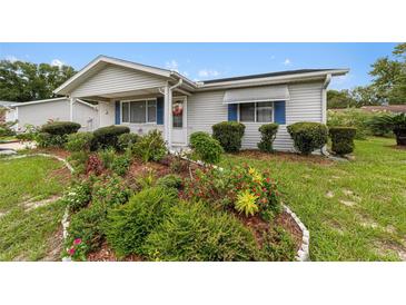 Cute ranch home with landscaped front yard and well-maintained lawn at 10978 Sw 83Rd Ave, Ocala, FL 34481