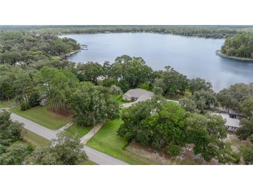 Lakefront home nestled among lush trees at 11196 Ne 227Th Place Rd, Fort Mc Coy, FL 32134