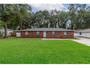 Brick ranch home with a large front yard at 5456 Nw 64Th St, Ocala, FL 34482