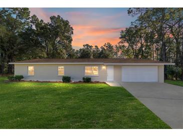 Charming house with a beautiful sunset view and well-maintained lawn at 11 Cedar Trace Crse, Ocala, FL 34472