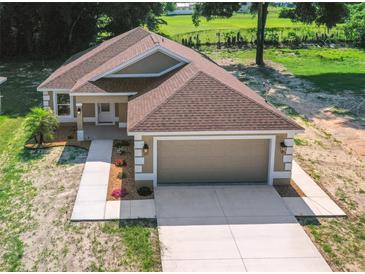 New single-Gathering home with a two-car garage and landscaped yard at 706 Stanley Ave, Wildwood, FL 34785