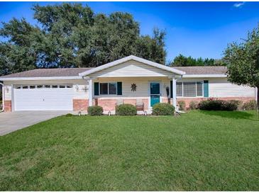 Charming ranch home with brick facade and green door at 10783 Se 178Th St, Summerfield, FL 34491