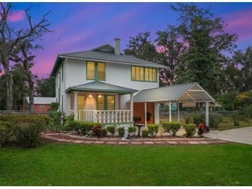 Two-story house with a covered porch and landscaping at 712 Sw 10Th Ave, Ocala, FL 34471