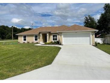 Newly constructed home with a well-manicured lawn and driveway at 4503 Sw 132Nd St, Ocala, FL 34473