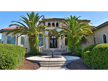 Two story house with palm trees and fountain at 1525 Se 59Th St, Ocala, FL 34480