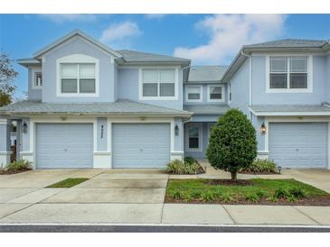 Two-story townhome with two-car garage and landscaped front yard at 4555 Sw 52Nd Cir # 101, Ocala, FL 34474