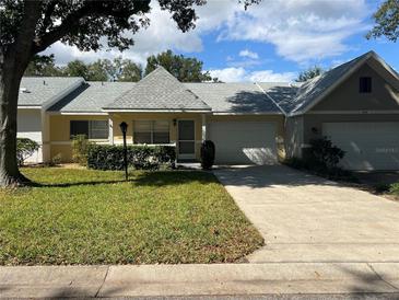 Cute two-bedroom villa with a well-maintained lawn at 9460 Sw 84Th Ter # E, Ocala, FL 34481