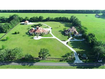 Aerial view of two large homes on a spacious lot with lush landscaping at 1485 & 1525 Se 59Th St, Ocala, FL 34480