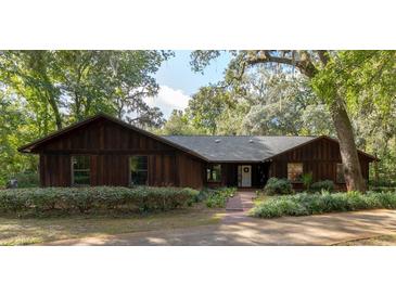 Ranch style home with wood siding and landscaping at 3630 Ne 67Th Ter, Silver Springs, FL 34488