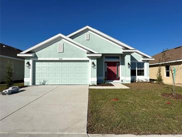 New construction home with two-car garage and red front door at 4489 Sw 90Th Pl, Ocala, FL 34476