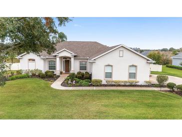 One-story home with light colored exterior, landscaping, and driveway at 4736 Se 34Th St, Ocala, FL 34480