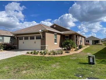 Two-story home with attached garage and landscaping at 10201 Sw 96Th Loop, Ocala, FL 34481