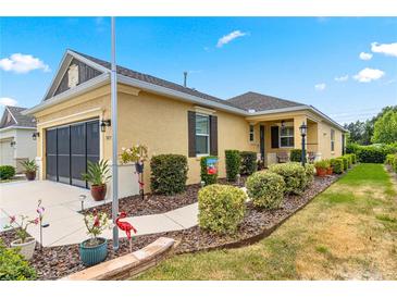 House exterior showcasing a manicured lawn and walkway at 9873 Sw 99Th Loop, Ocala, FL 34481