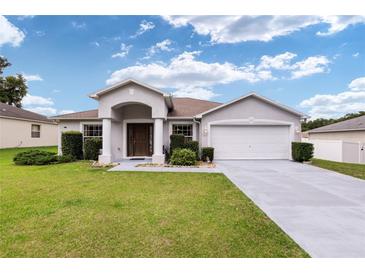 One-story house with two-car garage and manicured lawn at 3107 Ne 24 Pl, Ocala, FL 34470