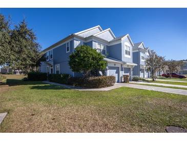 Two-story townhome with gray exterior, two-car garage, and landscaped lawn at 4415 Sw 52Nd Cir # 101, Ocala, FL 34474