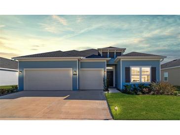 Two-story home with light blue siding and two-car garage at 7930 Sw 74Th Loop, Ocala, FL 34481