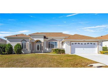 One-story home with a two-car garage and well-manicured lawn at 2350 Nw 59Th Ave, Ocala, FL 34482