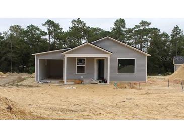 Newly constructed gray house with attached garage and small front yard at 15934 Sw 41St St, Ocala, FL 34481