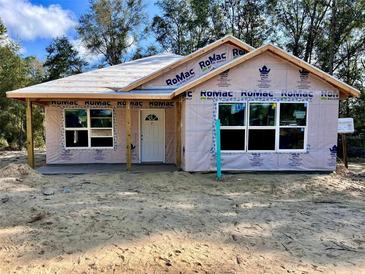 Newly constructed one-story home with a covered porch at 14173 Se 41St Ter, Summerfield, FL 34491