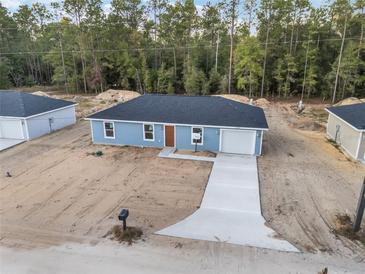 New construction home with a one-car garage and driveway at 15397 Sw 29 St, Ocala, FL 34481