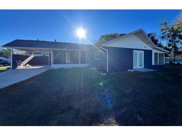 Newly painted house with carport and screened porch at 481 Spring Ln, Ocala, FL 34472