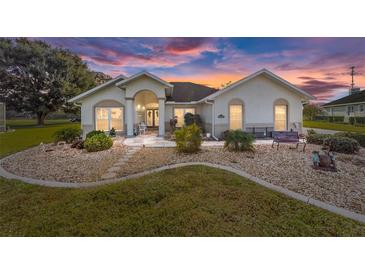 Beautiful one-story home with landscaped yard and walkway at 1409 Meadow View Way, Lady Lake, FL 32159