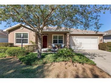Single-story home with landscaped yard and two-car garage at 9350 Sw 91St Court Rd, Ocala, FL 34481