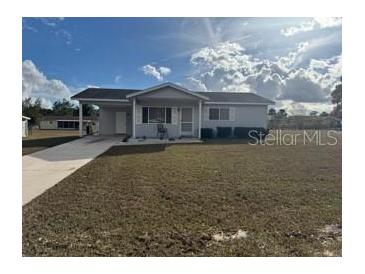 One-story home with gray siding, driveway, and small front yard at 8152 Sw 106Th St, Ocala, FL 34481