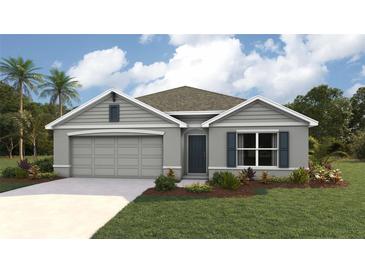 One-story home with gray siding, two-car garage, and landscaped lawn at 8838 Sw 48Th Ave, Ocala, FL 34476