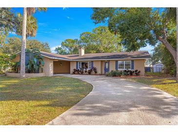 Ranch style home with circular driveway and mature landscaping at 21 Se Ocale Way, Summerfield, FL 34491