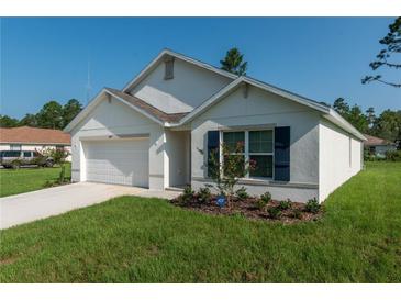 Newly constructed home with a white exterior, two-car garage, and landscaping at 3649 Sw 177Th Lane Rd, Ocala, FL 34473