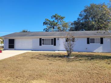 Ranch-style home with attached garage and spacious yard at 10865 Sw 78Th Ct, Ocala, FL 34476