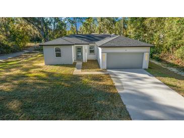 Newly constructed home with gray garage and modern design at 4 Oak Cir, Ocala, FL 34472