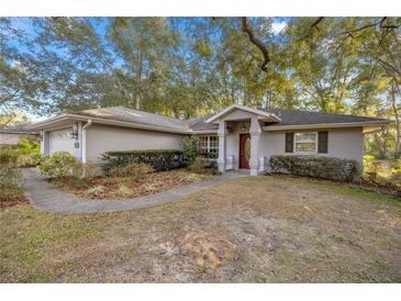 One-story home with attached garage and landscaped yard at 2401 Se 49Th Ave, Ocala, FL 34480