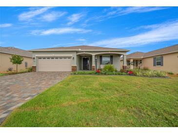 Charming single-story home with a paved driveway and landscaped front yard at 7932 Sw 89Th Cir, Ocala, FL 34481