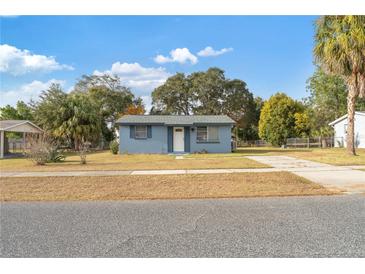 Charming blue single-story home with a front yard and driveway at 3779 Sw 147Th Lane Rd, Ocala, FL 34473