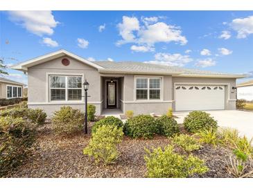 Charming single-story home with a welcoming front entrance and landscaped yard at 8847 Sw 104Th Cir, Ocala, FL 34481