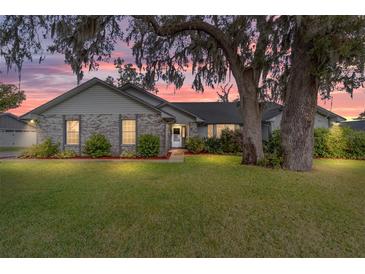 Charming single-Gathering home with brick and siding exterior at sunset at 4451 Sw 44Th Ln, Ocala, FL 34474