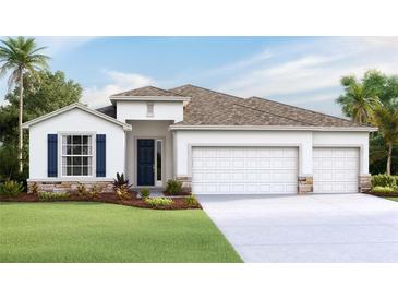 Charming single-story home with a three-car garage and landscaped front yard at 3092 Canopy Oak Blvd, Wildwood, FL 34785
