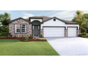 Inviting single-story home with a three-car garage and stone accents at 3095 Canopy Oak Blvd, Wildwood, FL 34785