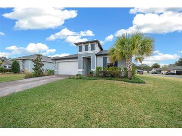 Inviting two-story home with a well-maintained lawn and palm trees at 3810 Se 4Th Ter, Ocala, FL 34480