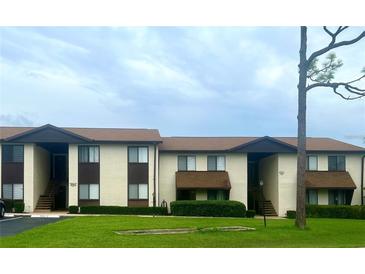 Two-story condo building with well-maintained landscaping and ample parking at 548 Fairways Dr # B, Ocala, FL 34472