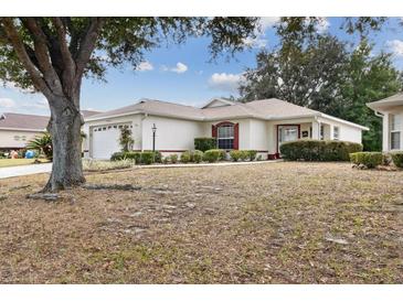 One-story home with a two-car garage and well-manicured lawn at 9646 Sw 92 Place Rd, Ocala, FL 34481