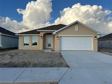 New construction home with attached garage and neutral color scheme at 4477 Sw 90Th Pl, Ocala, FL 34476