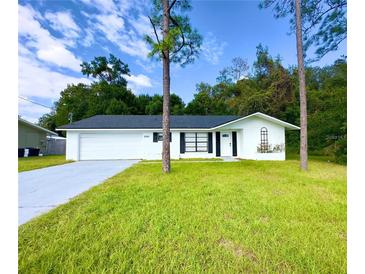 Newly renovated single story home with a large grassy yard at 21111 Sw Honeysuckle St, Dunnellon, FL 34431