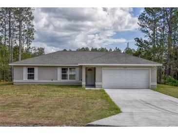 Newly constructed single-story home with a two-car garage and neutral color scheme at 8585 Sw 139Th Lane Rd, Ocala, FL 34473