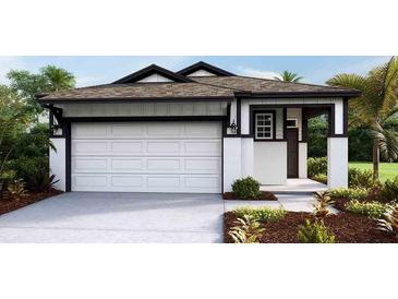 White house with dark trim, two-car garage, and landscaping at 4072 Nw 44Th Cir, Ocala, FL 34482