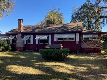 Ranch-style home with a large yard and mature trees at 1175 Cr 463B, Lake Panasoffkee, FL 33538