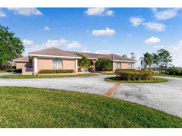Beautiful home with circular driveway and landscaping at 3082 Landings Ct, Haines City, FL 33844